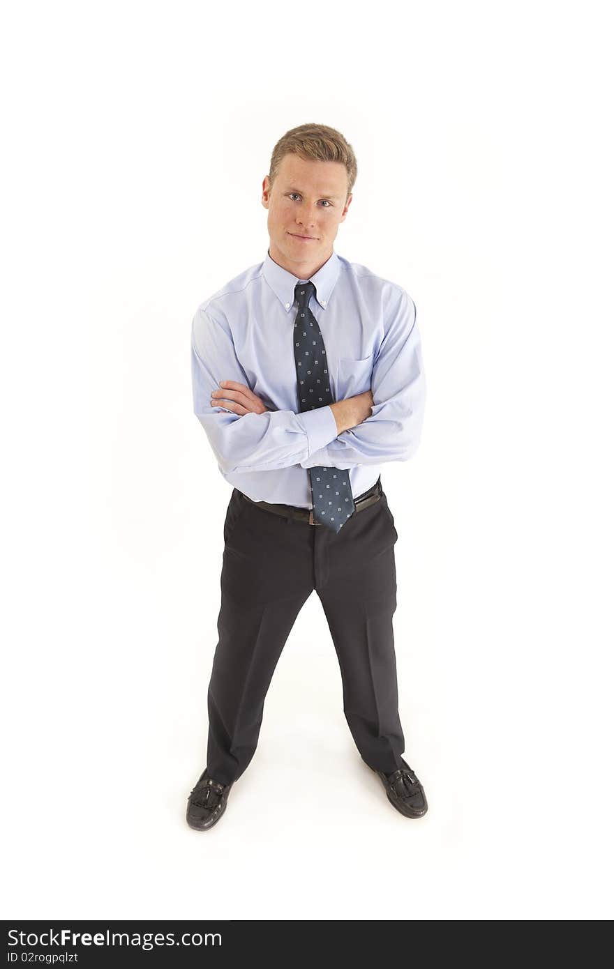 Smiling young businessman with arms crossed