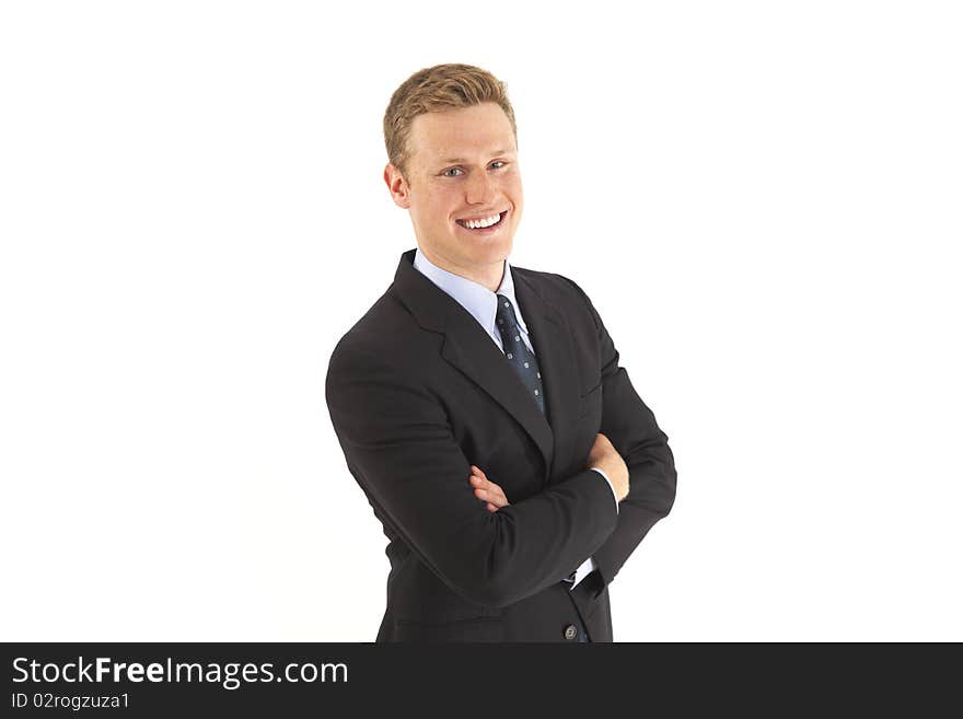 Smiling businessman in suit with arms crossed