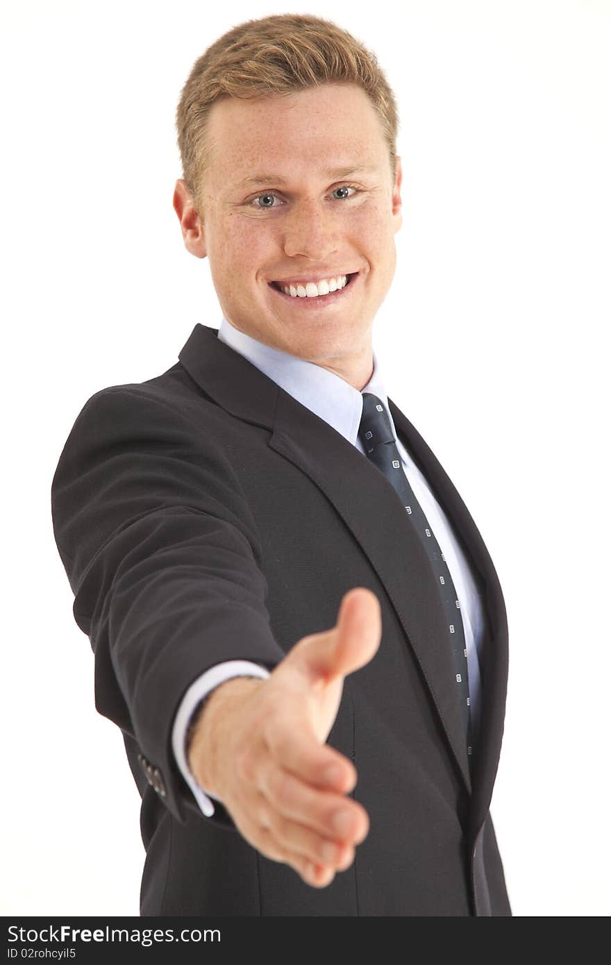 Portrait of young businessman holding out hand for a handshake. Portrait of young businessman holding out hand for a handshake