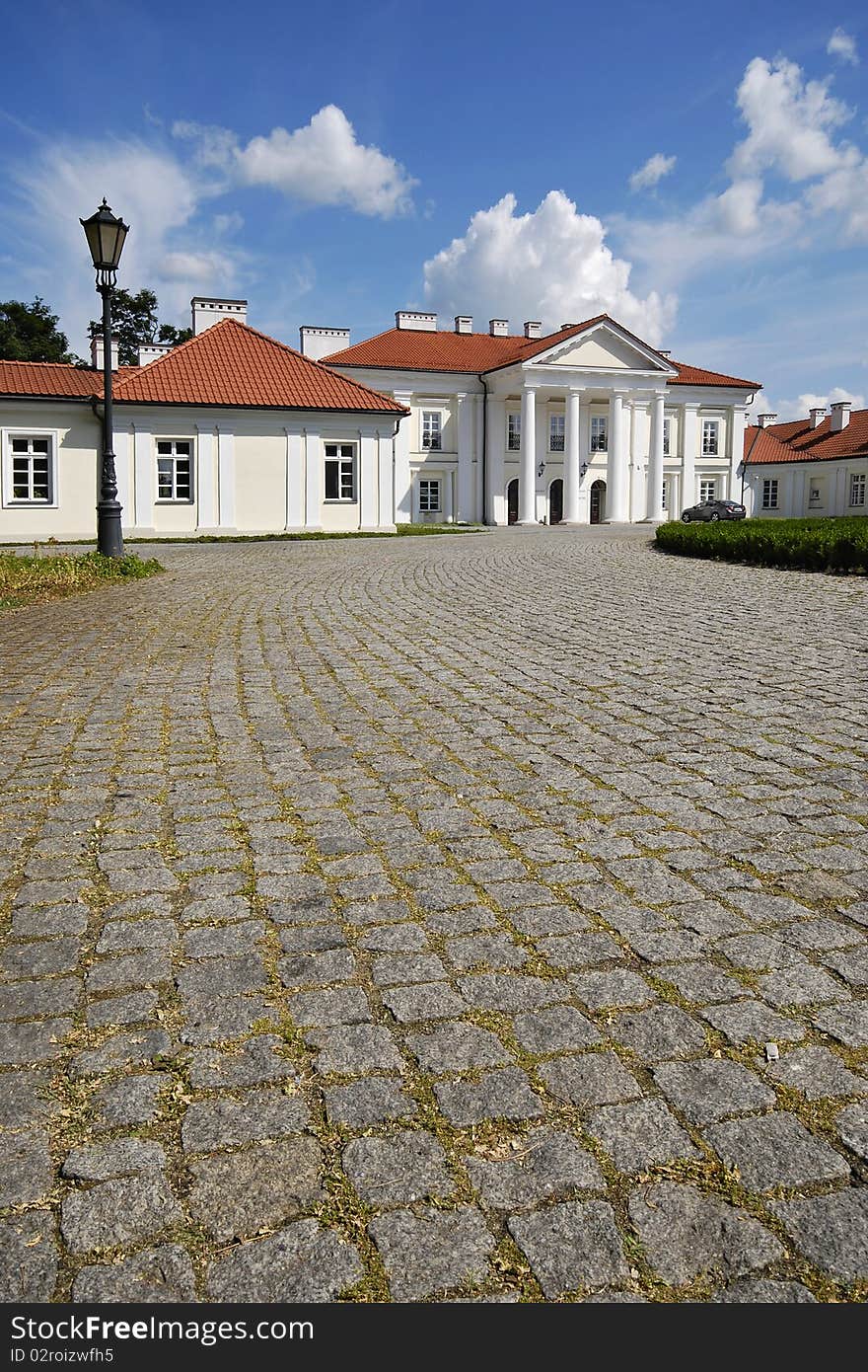 Classical palace with the garden into a sunny day