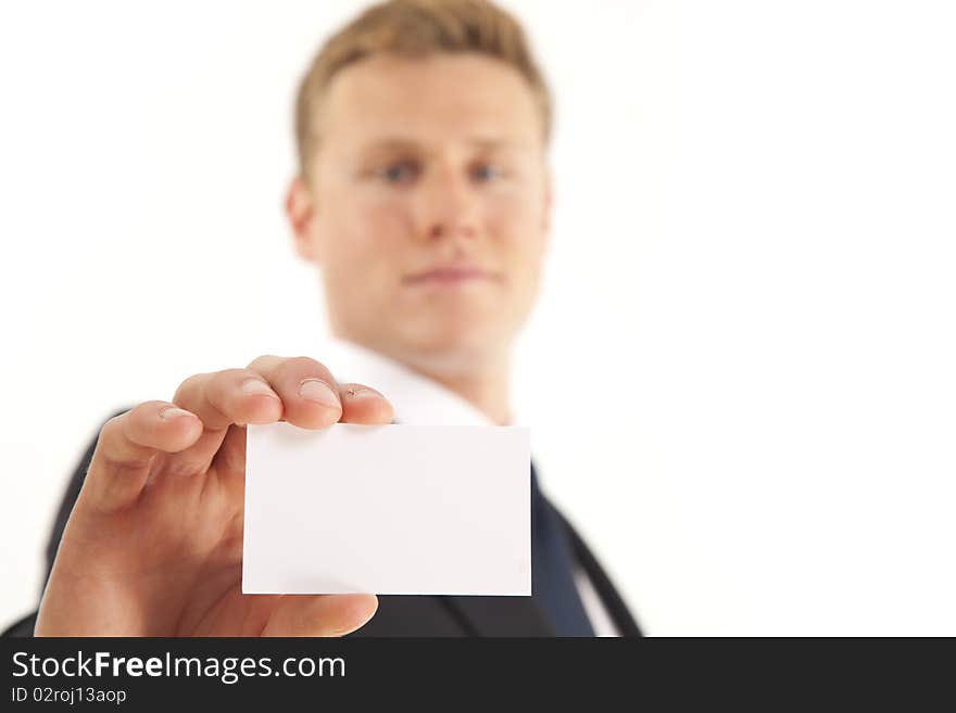 Head and shoulder portrait of businessman holding blank business card