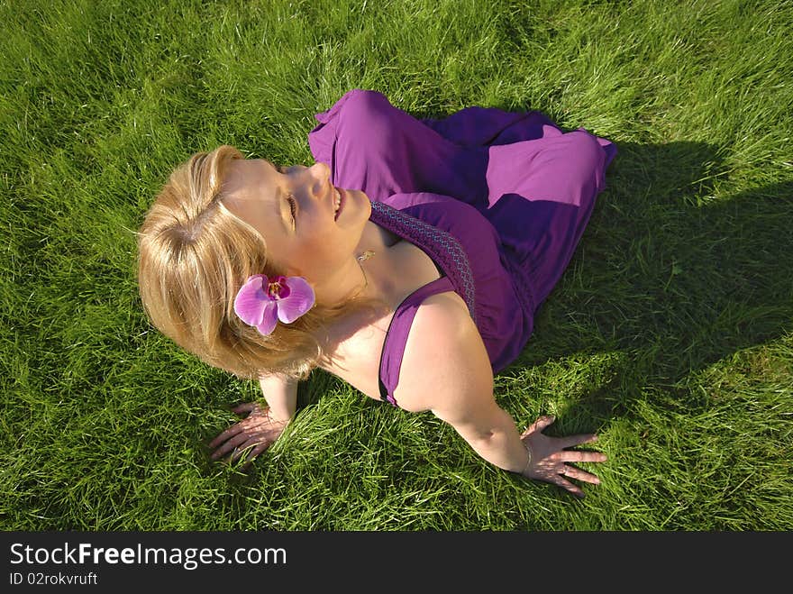 Pregnant woman sitting on the grass