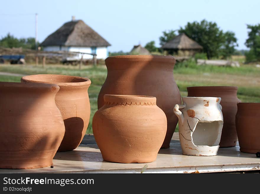 Clay the pots of handwork stand on a background rural landscape. Clay the pots of handwork stand on a background rural landscape