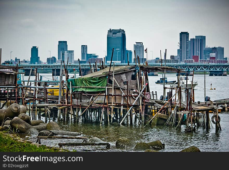 A rotten boat pier with steady toll building in the background. A rotten boat pier with steady toll building in the background