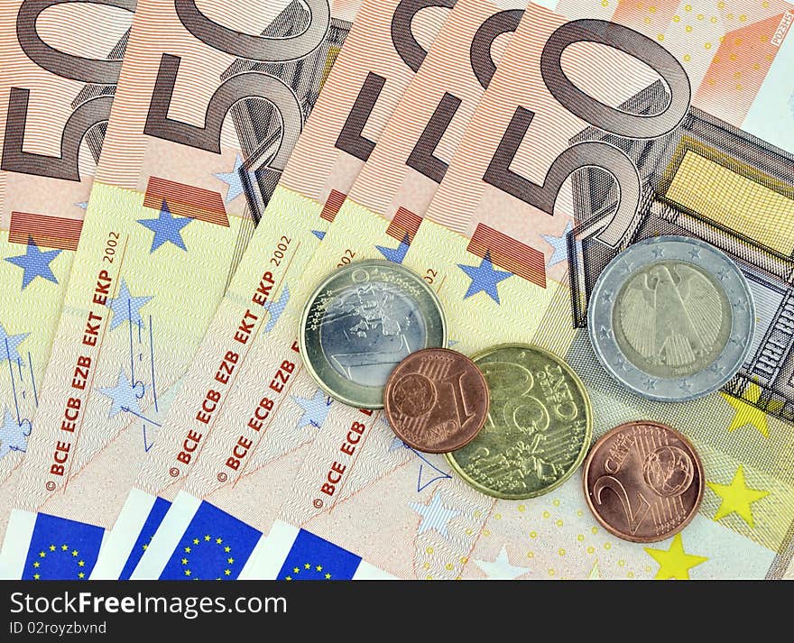 Closeup of fifty euro banknotes with coins. Closeup of fifty euro banknotes with coins