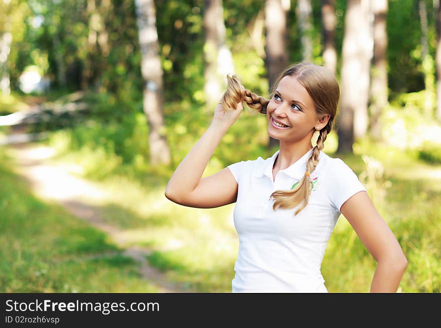 Young beautiful girl in a summer forest