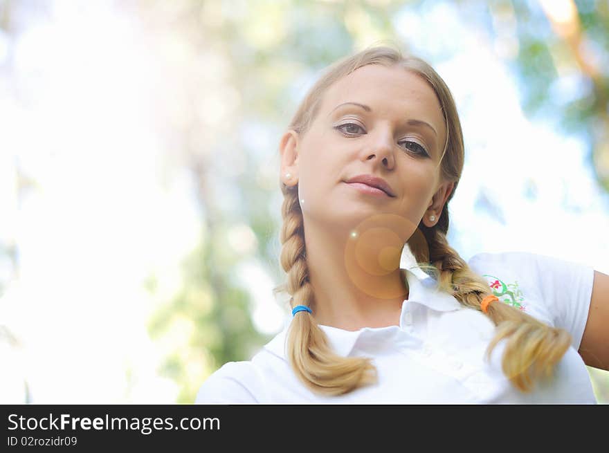 Young beautiful girl in a summer forest