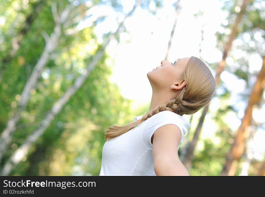 Young beautiful girl in a summer forest