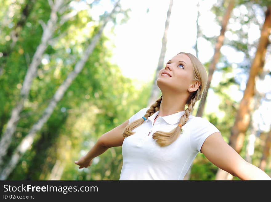 Young beautiful girl in a summer forest