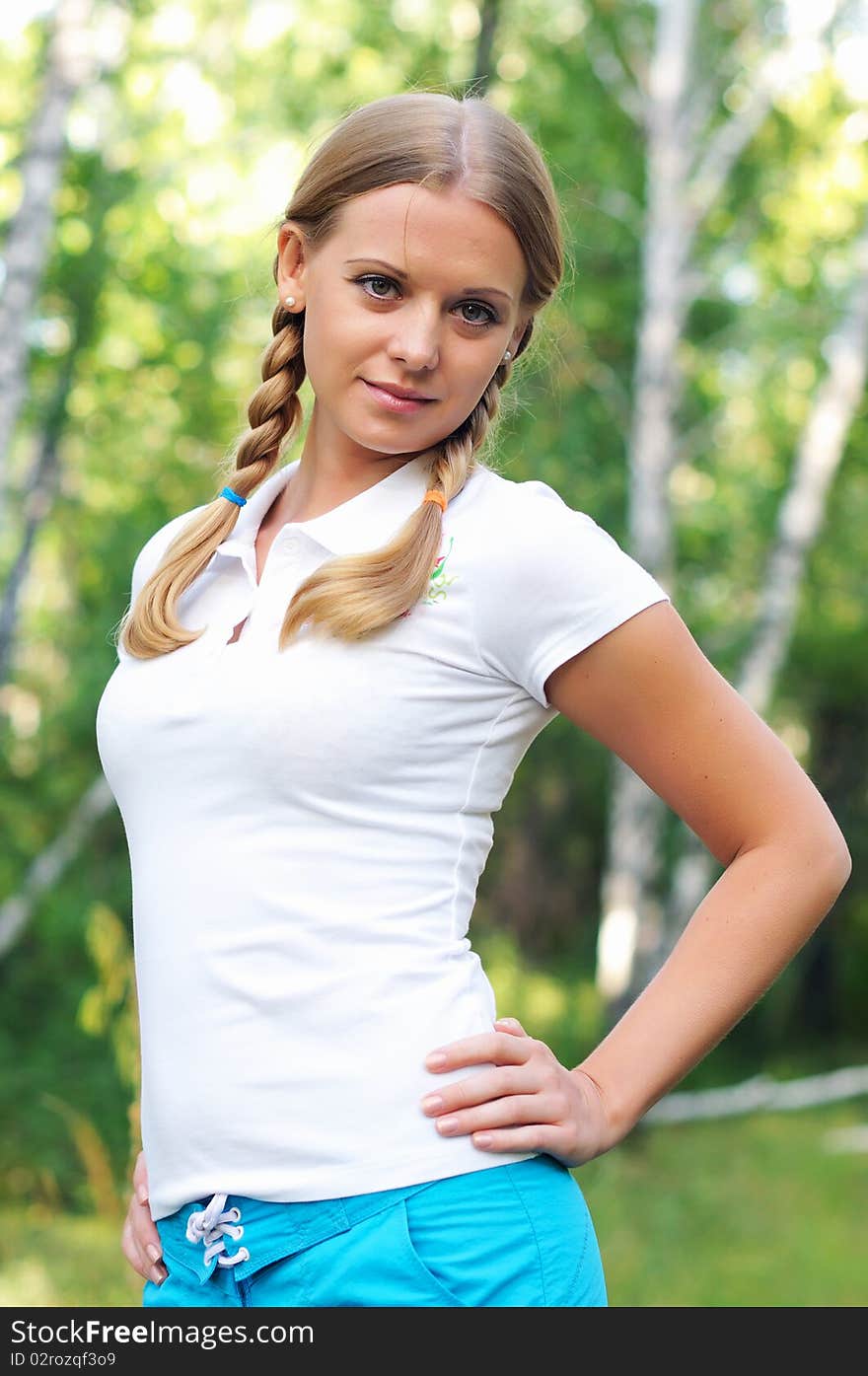 Young beautiful girl in a summer forest