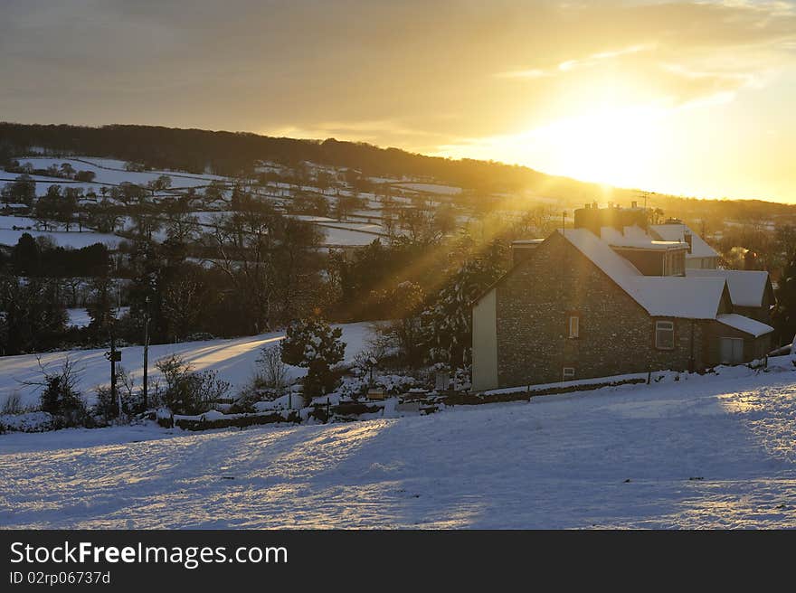 Late afternoon sun bathes a snowy Hemyock in Devon. Late afternoon sun bathes a snowy Hemyock in Devon