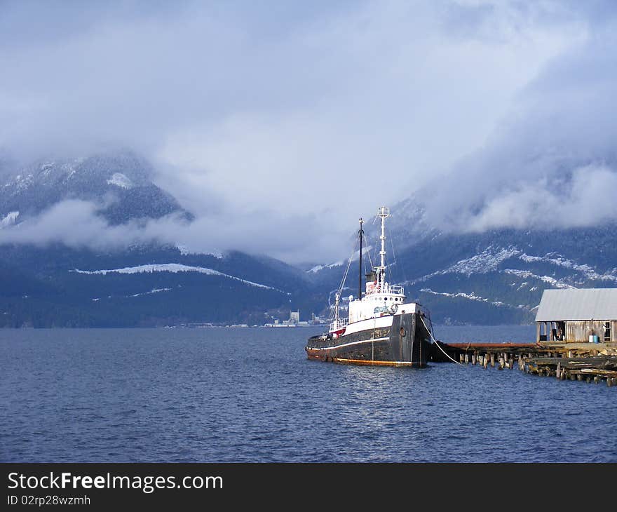 A view of tug boat among mountains, Britannia Beach, Squamish, British Columbia, Canada. A view of tug boat among mountains, Britannia Beach, Squamish, British Columbia, Canada