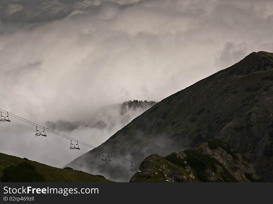 Cable lift in the high Tatras above dense clouds. Cable lift in the high Tatras above dense clouds