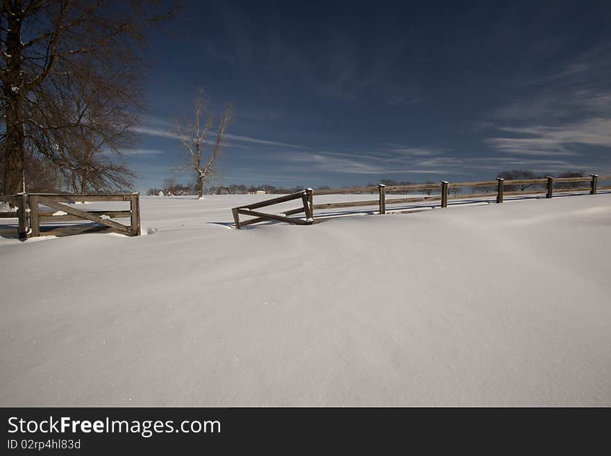 Broken fence in the country side in the winter. Broken fence in the country side in the winter