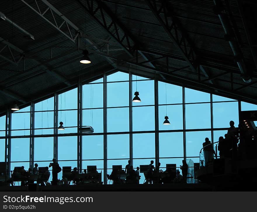 Cafe in the modern glass building. Backlight. Cafe in the modern glass building. Backlight