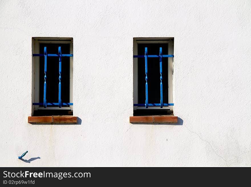 Windows with blue and white wall grates