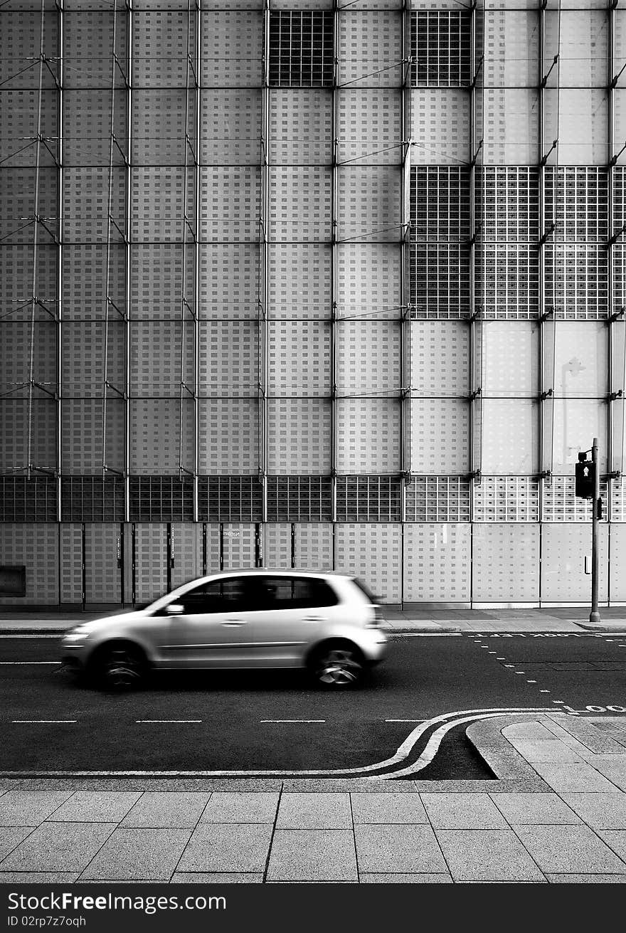 Car passing building in Canary Wharf Banking district. Car passing building in Canary Wharf Banking district