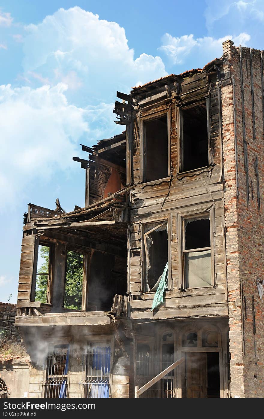 Abandoned old house burned by fire collapsing after a huge earthquake.