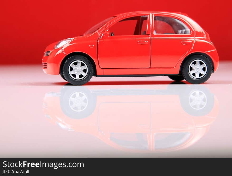 Nissan micra car shot in studio with red background.