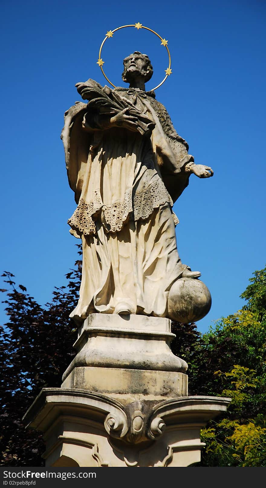 Monument of saint on the blue sky