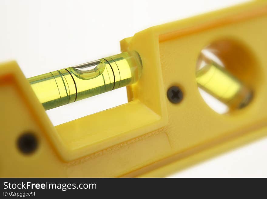 Yellow spirit level on white background