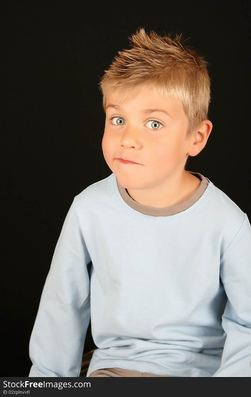 Cute blond boy on a black background. Cute blond boy on a black background