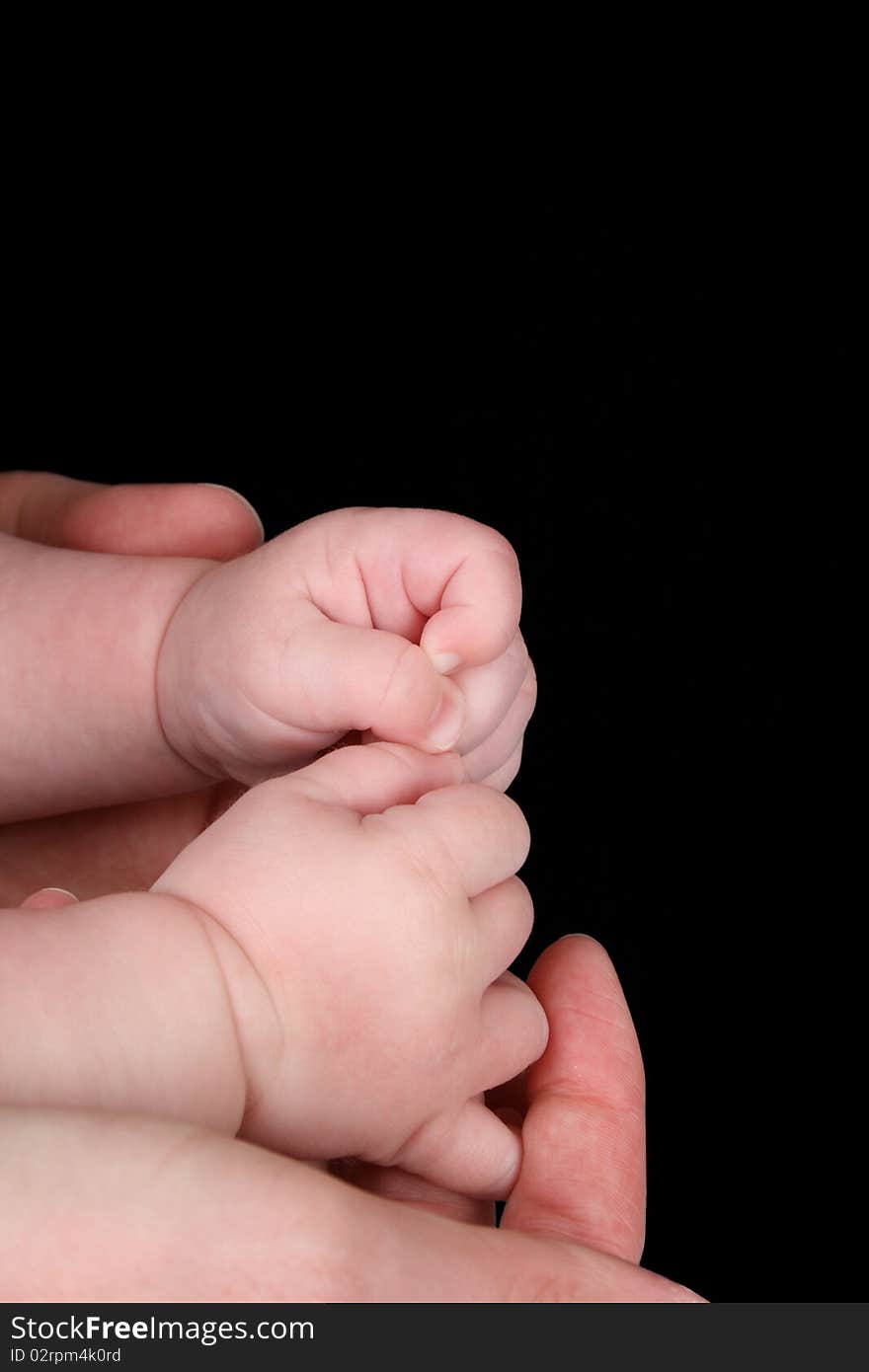 Caucasian mother and baby, baby holding mother's thumb. Caucasian mother and baby, baby holding mother's thumb