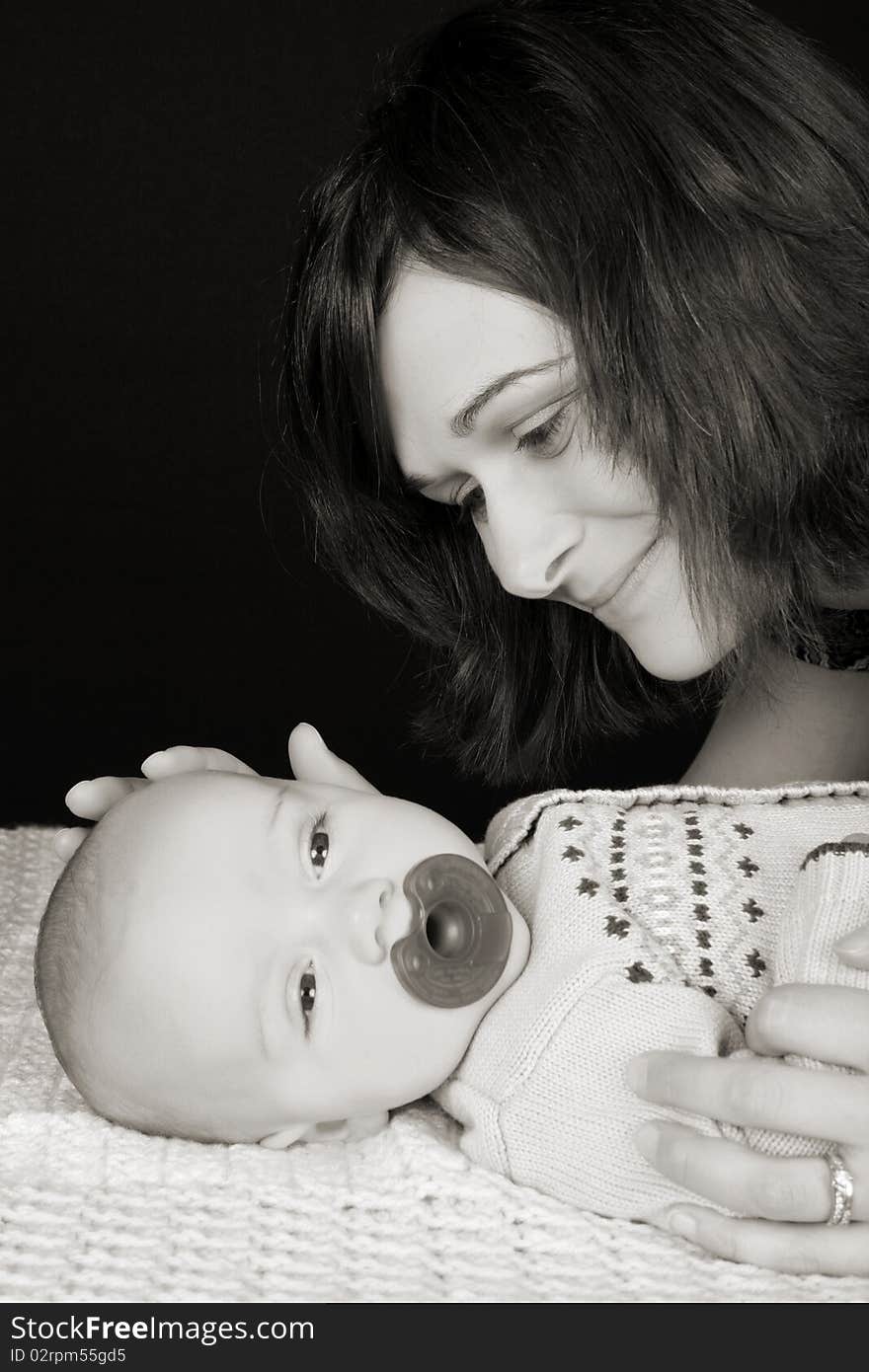 Beautiful mother and son against a black background