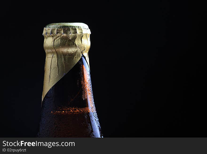 Closeup shot of beer bottle crown with black background.