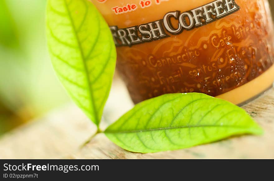 Backgroud coffee cup with green leaves