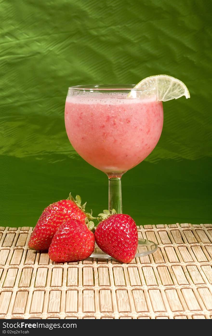 A refreshing smoothie with strawberries and a lime garnish. A refreshing smoothie with strawberries and a lime garnish.