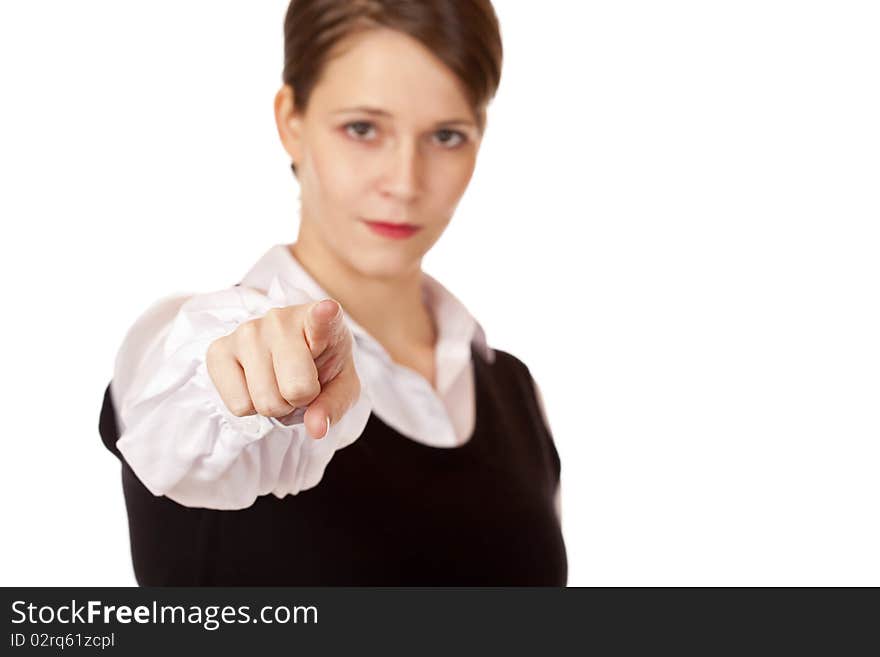 Serious looking businesswoman points with finger on camera. Isolated on white background.