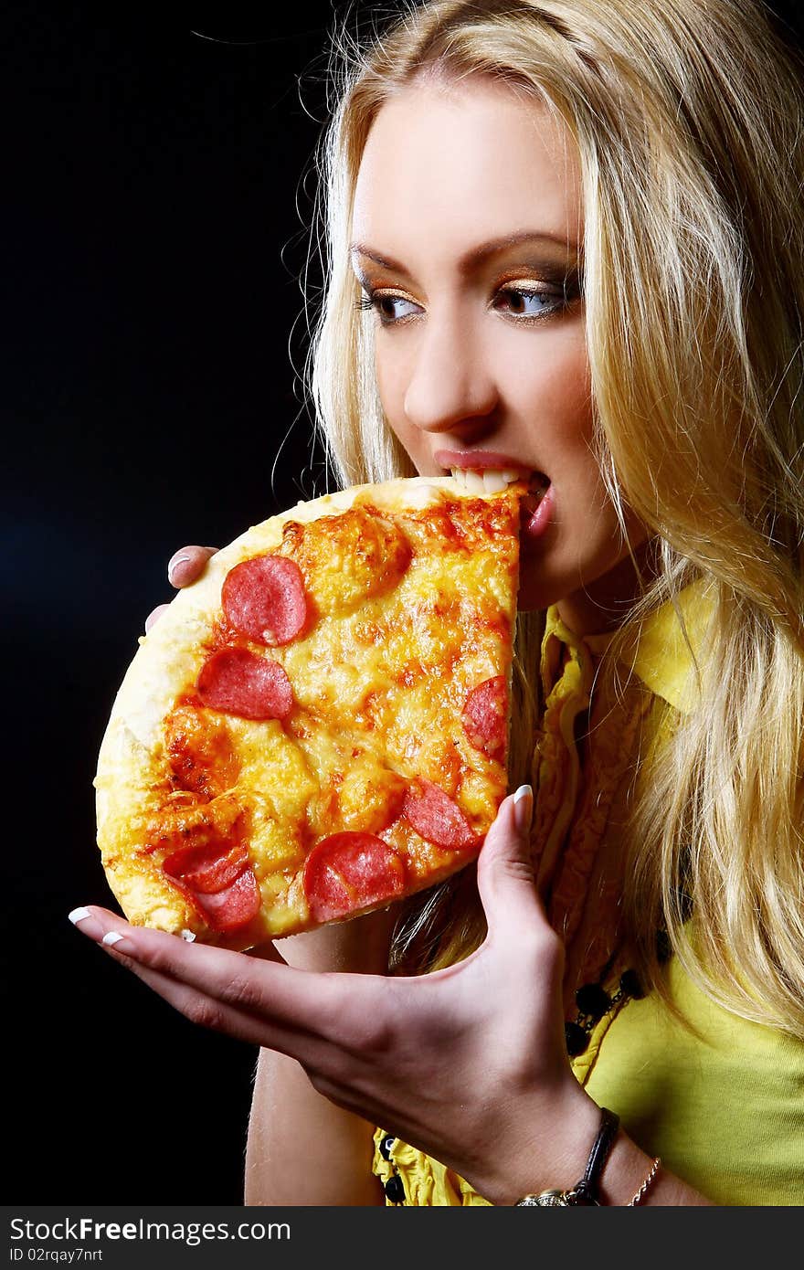 Beautiful woman eating fresh and tasty pizza