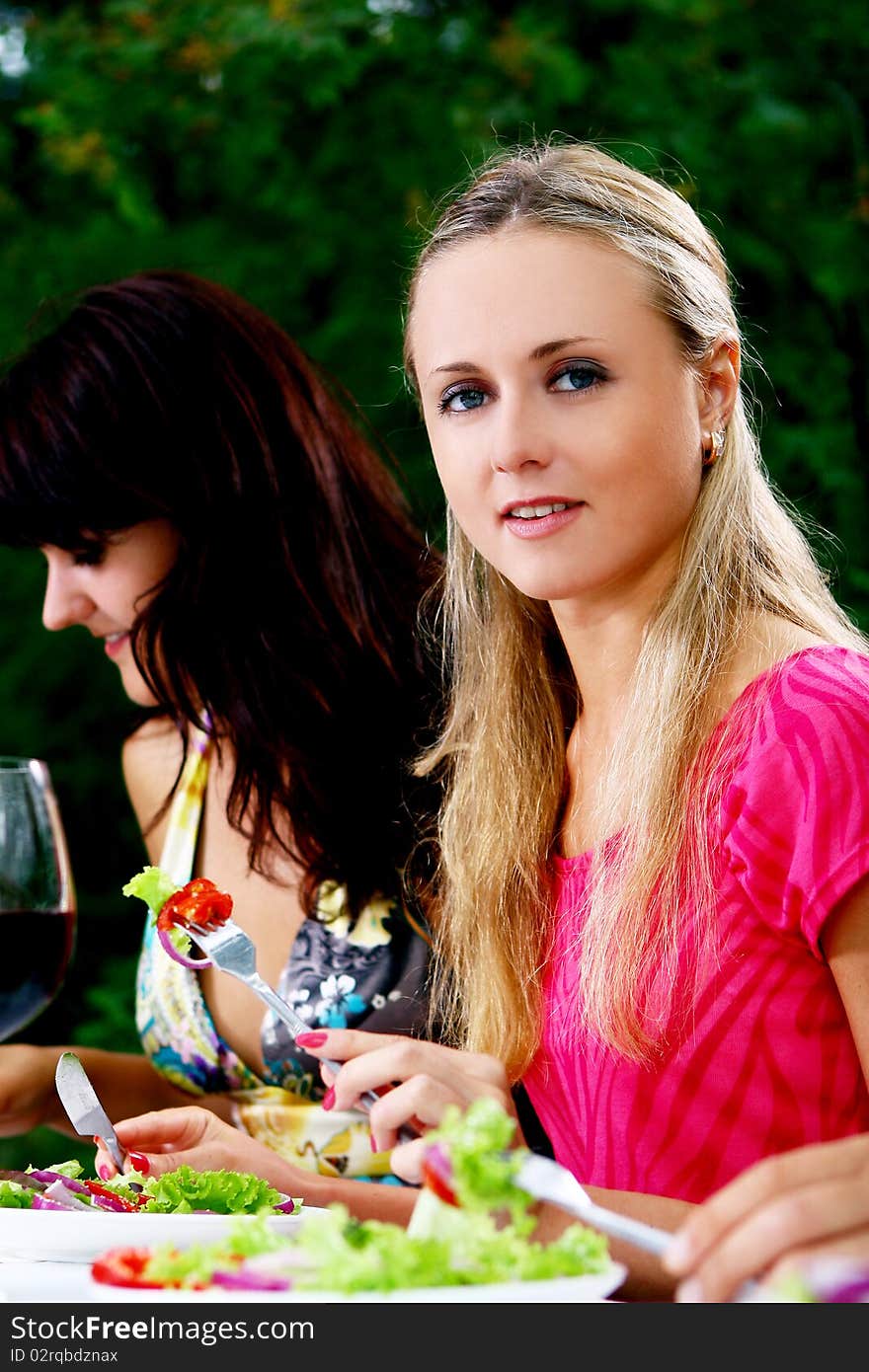 Group of beautiful girls drinking wine in the park