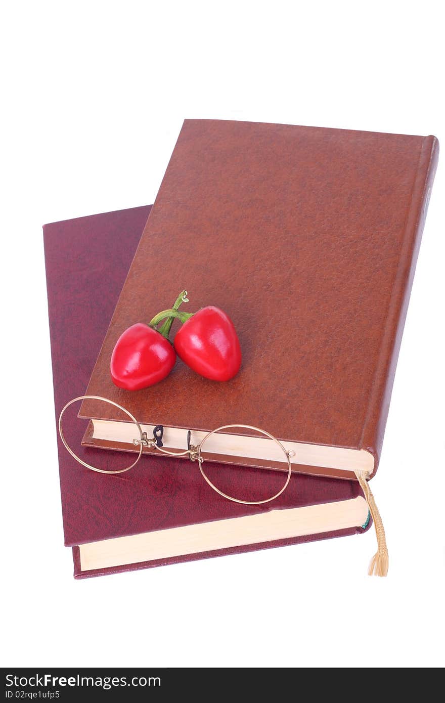 Old Books, Glasses And Chillies Isolated On White