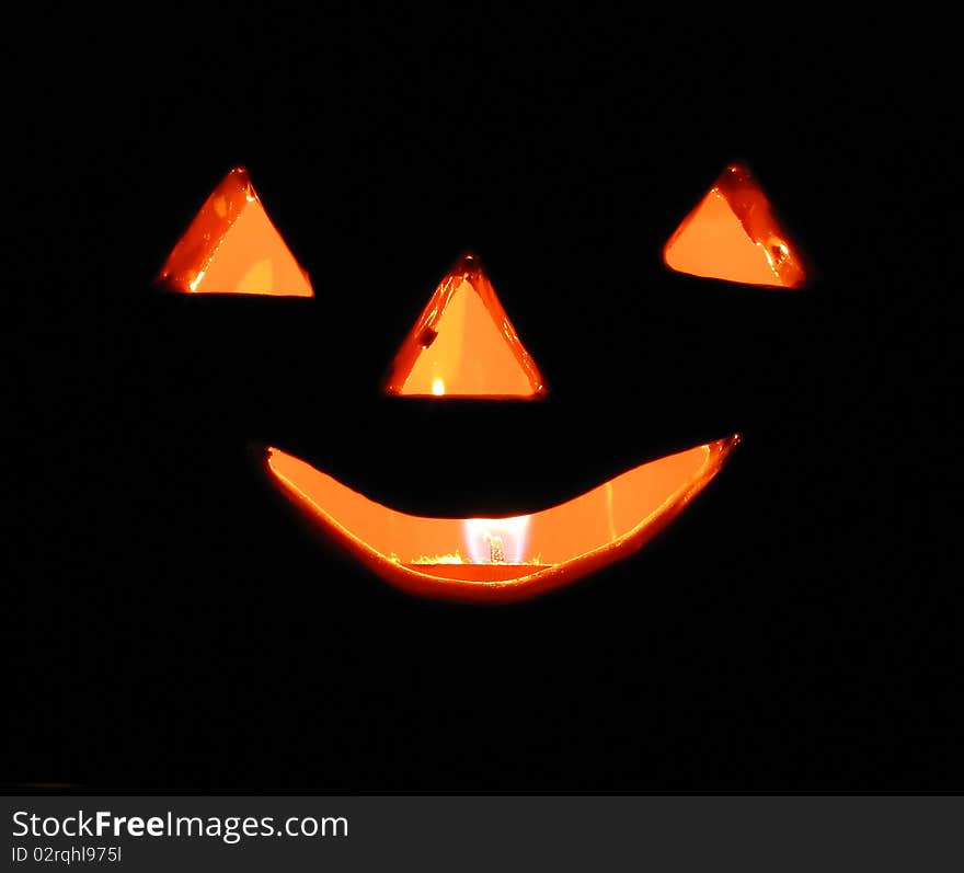 Candle inside a ceramic pumpkin