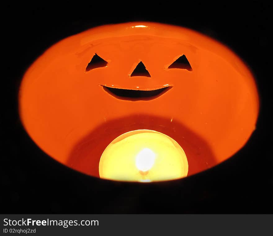 Candle inside a ceramic pumpkin