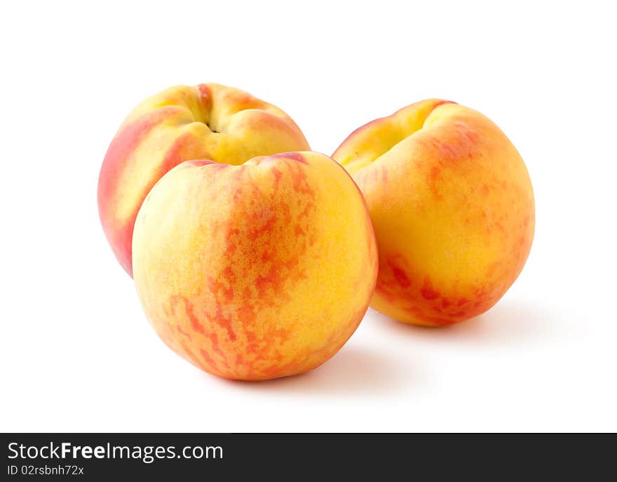 Three peaches on a white backgroundand with soft shadow