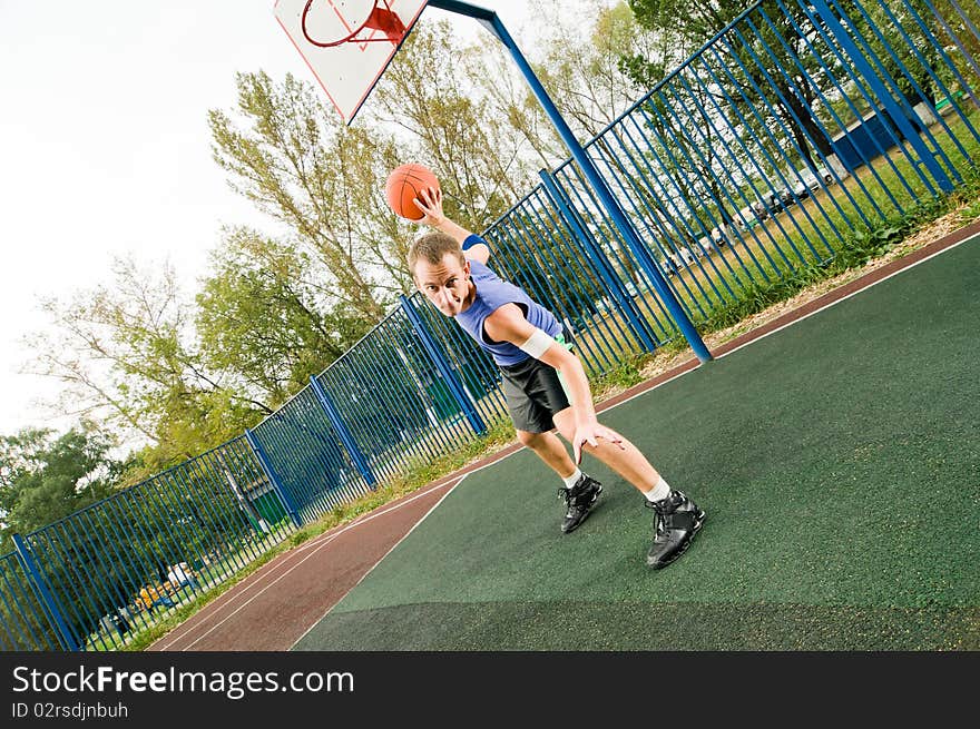 Young men playing street basketball. Young men playing street basketball