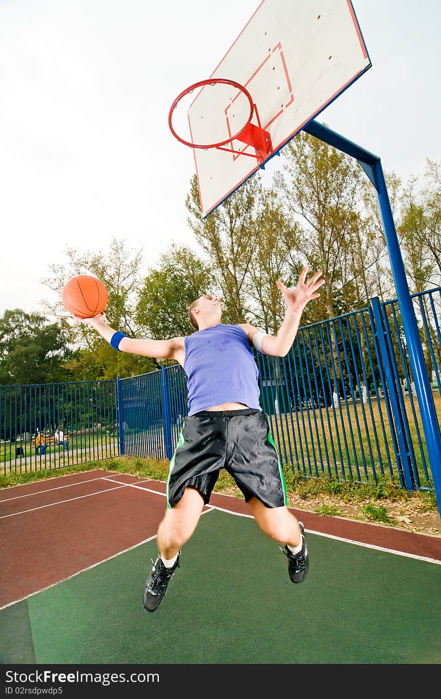 Young men playing street basketball. Young men playing street basketball