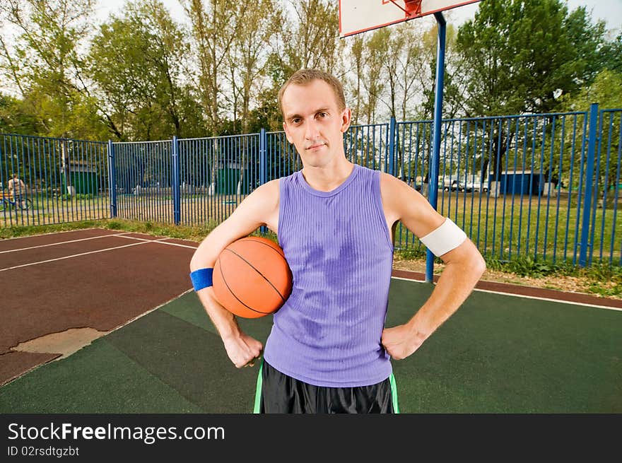 Young men playing street basketball. Young men playing street basketball