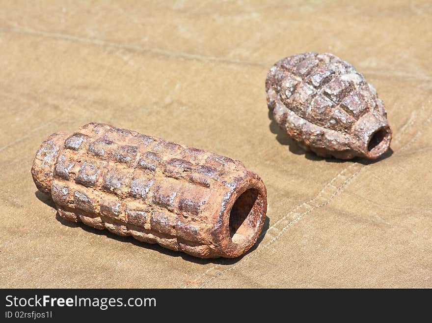 Old defused World War II high-explosive shells lying on the tarpaulin. Old defused World War II high-explosive shells lying on the tarpaulin