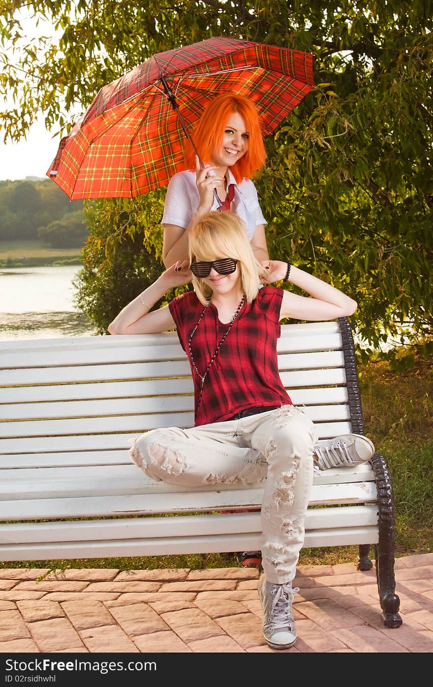 Two teenage girls have fun at the summer park