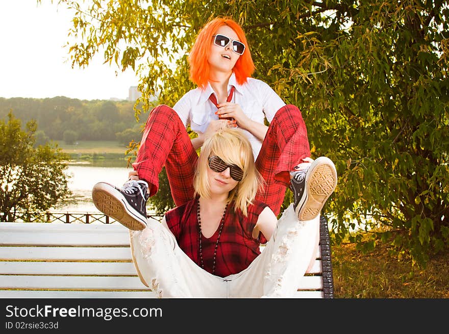 Two teenage girls have fun at the summer park