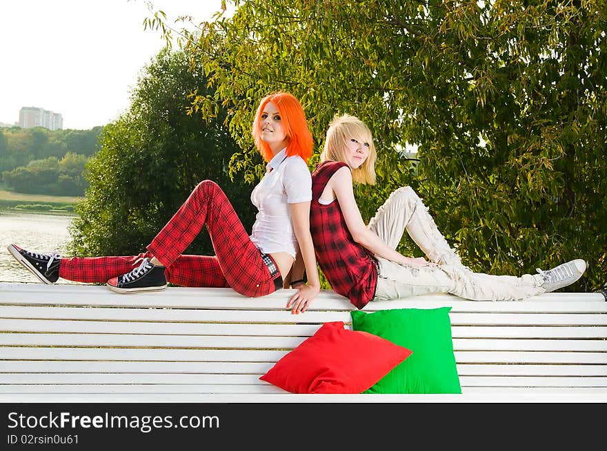 Two teenage girls have fun at the summer park