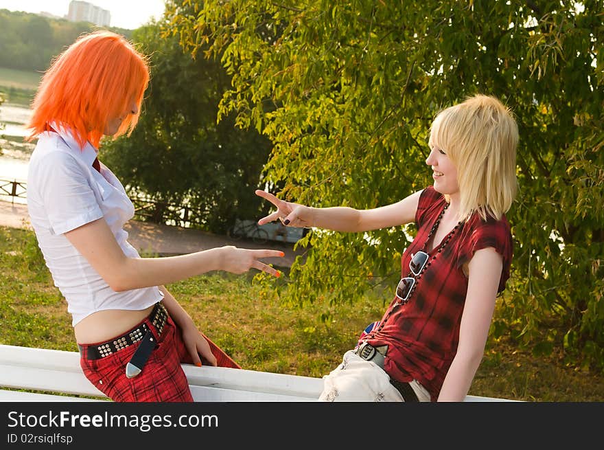 Two teenage girls have fun at the summer park