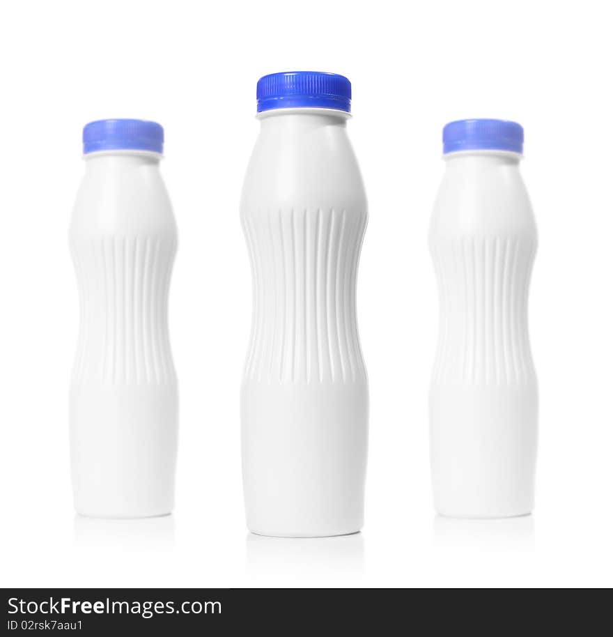 Three blank plastic bottles isolated on white. Depth of field effect