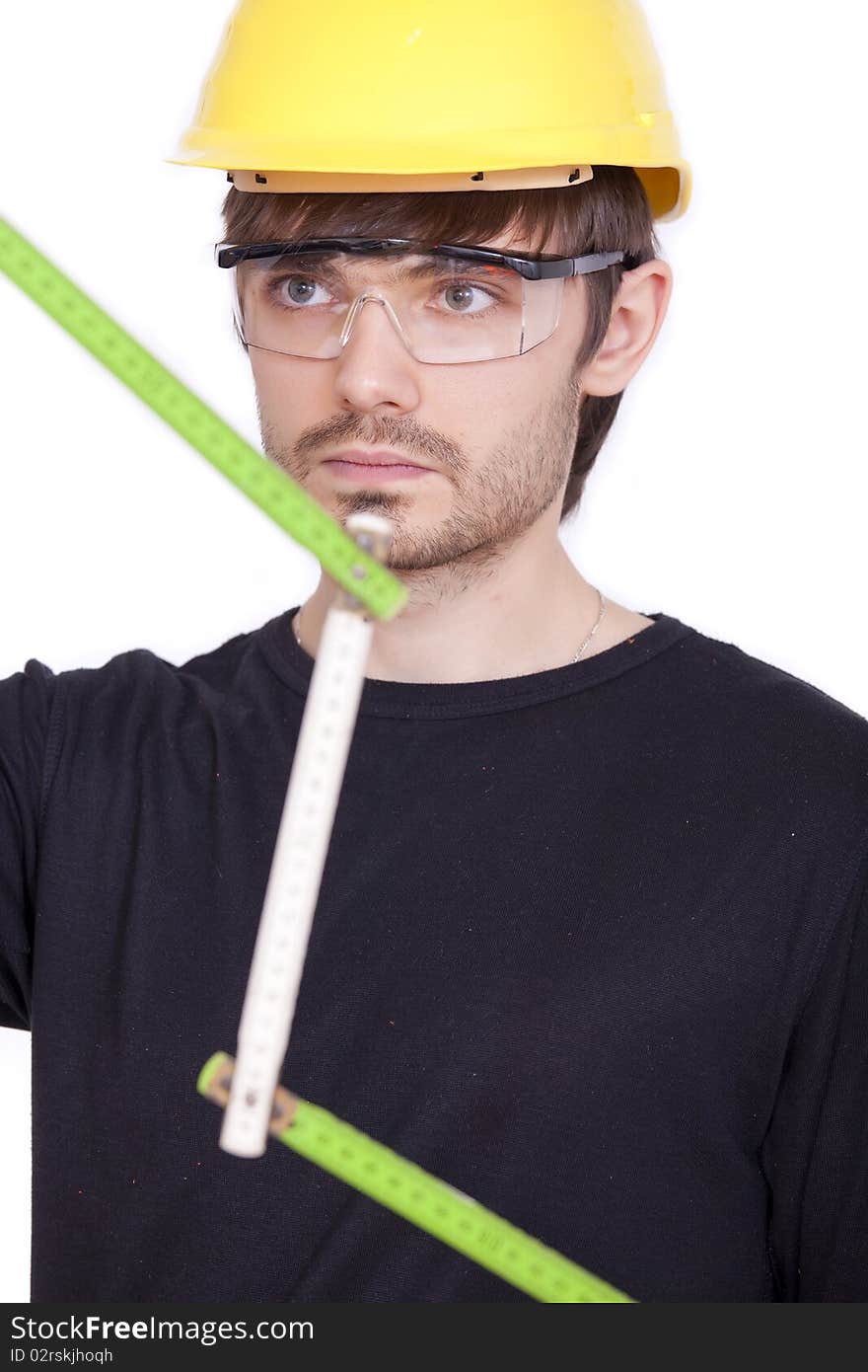 Portrait of construction worker with folding rule on white background