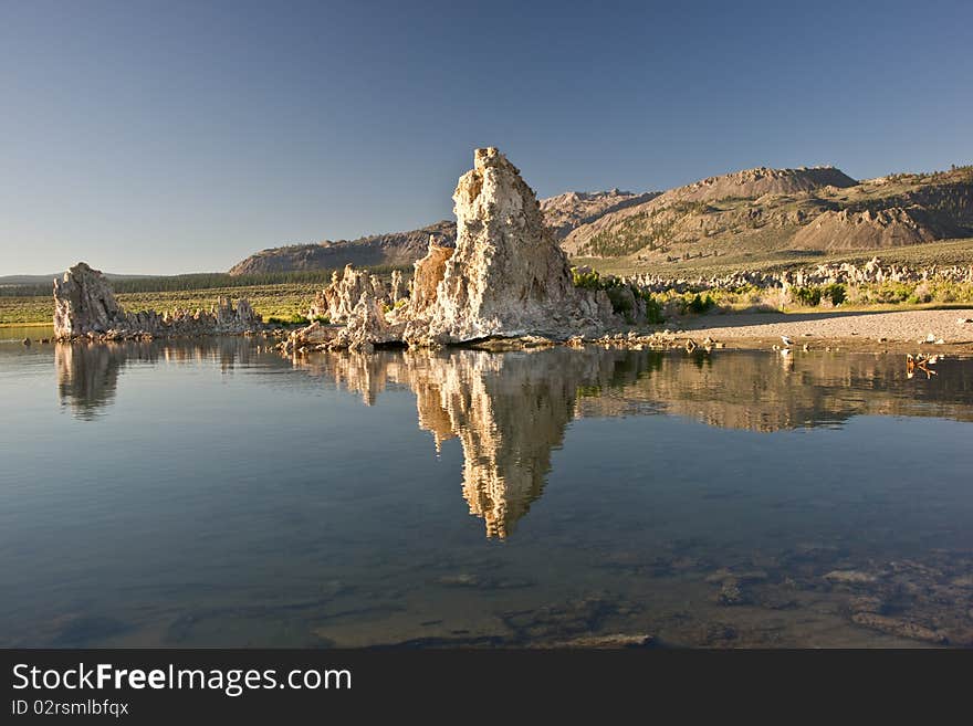 Reflections of tufa formations at Mono Lake at sunrise. Reflections of tufa formations at Mono Lake at sunrise