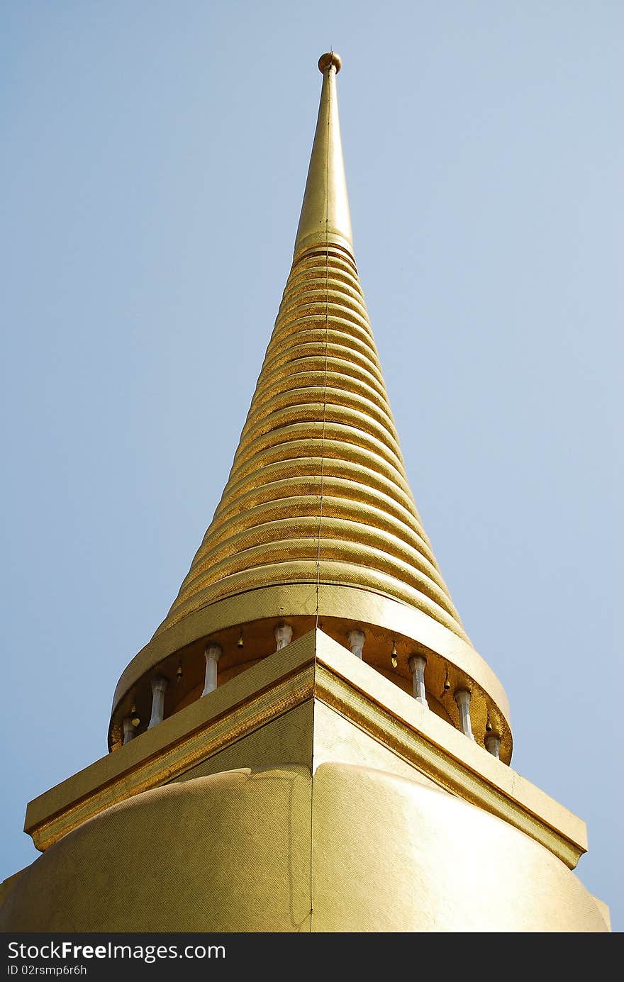 The peak of Golden Buddha Pagoda with details on the blue sky background